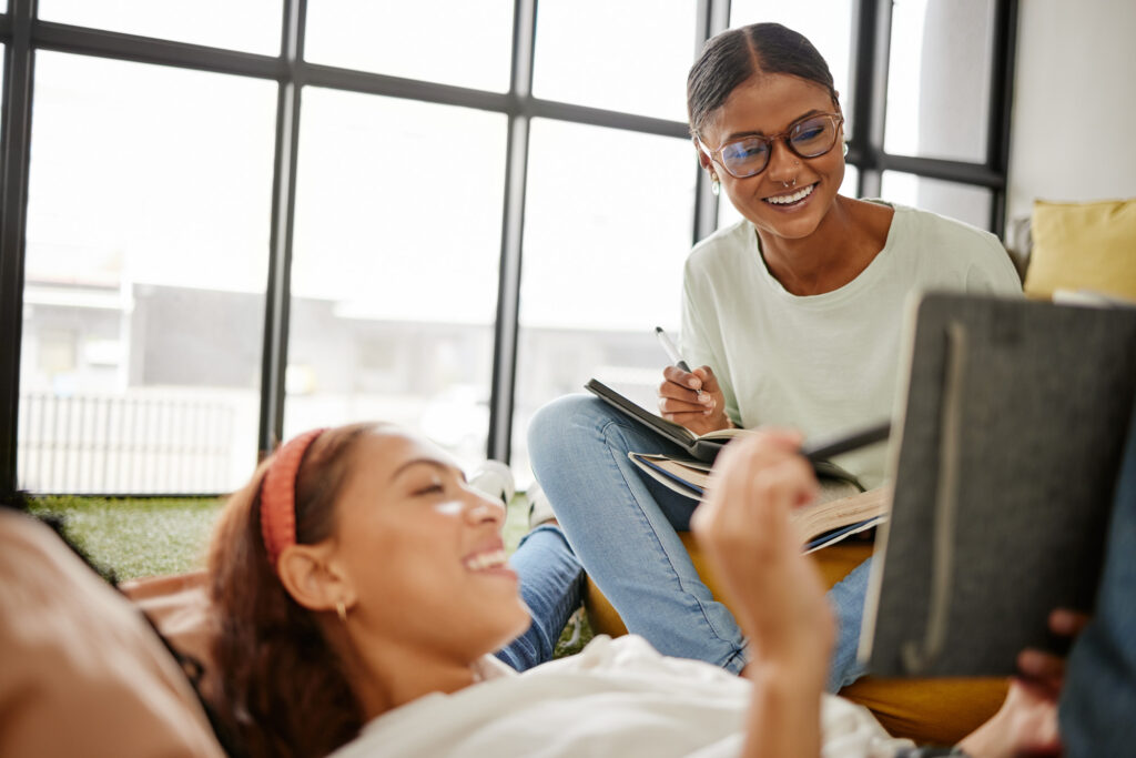 Two college students smile and study